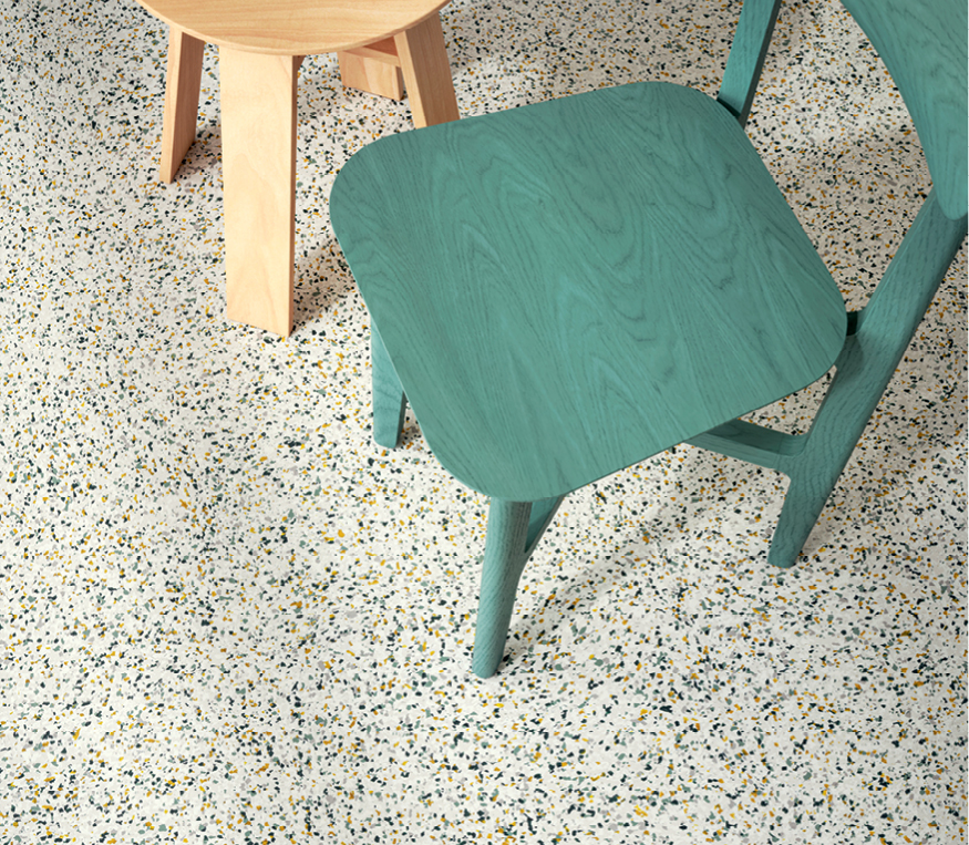 Green chair with small wooden table on Admix resilient floor