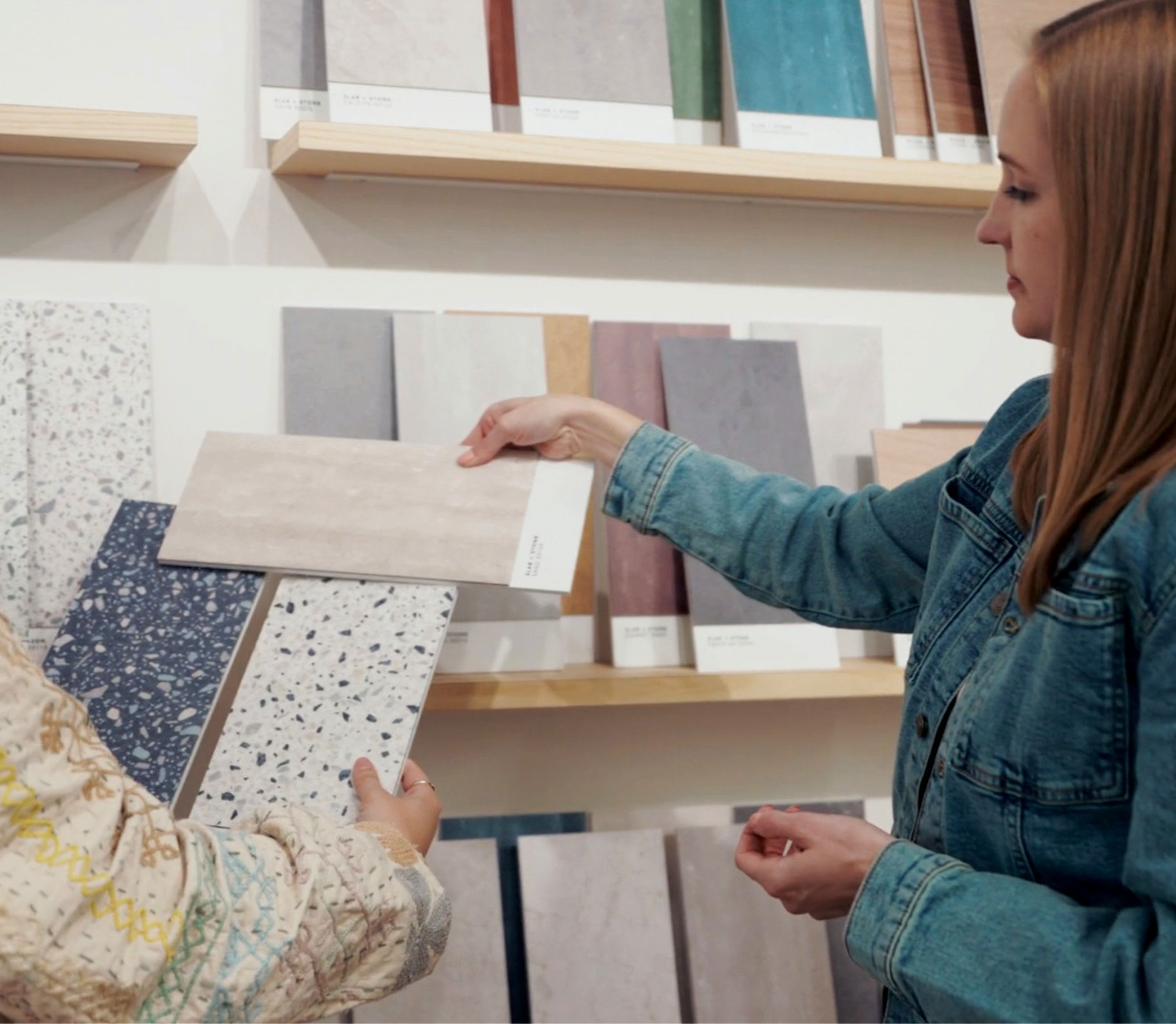 A woman holding flooring samples